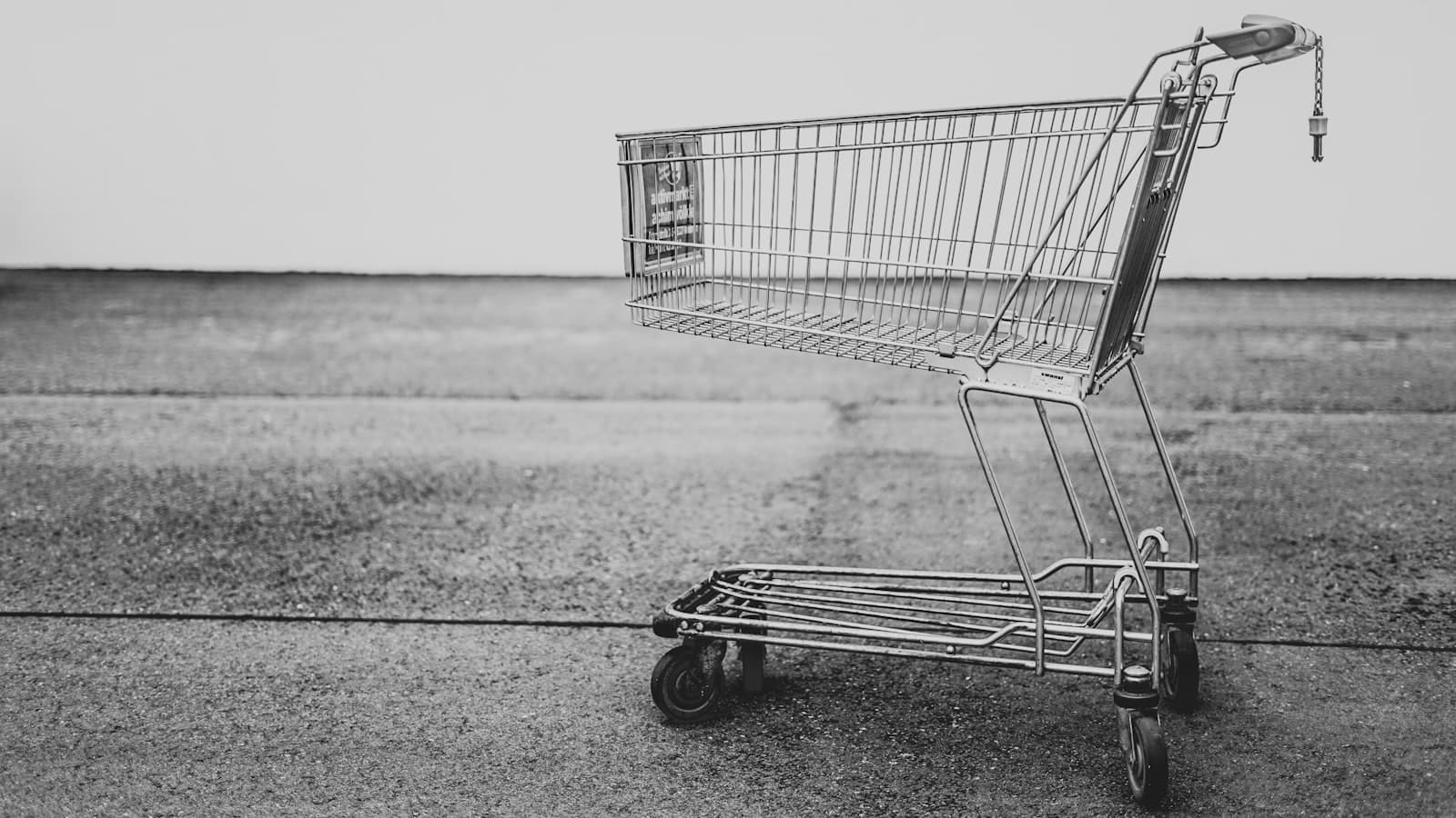 Miniature shopping cart on a laptop keyboard symbolising e-commerce